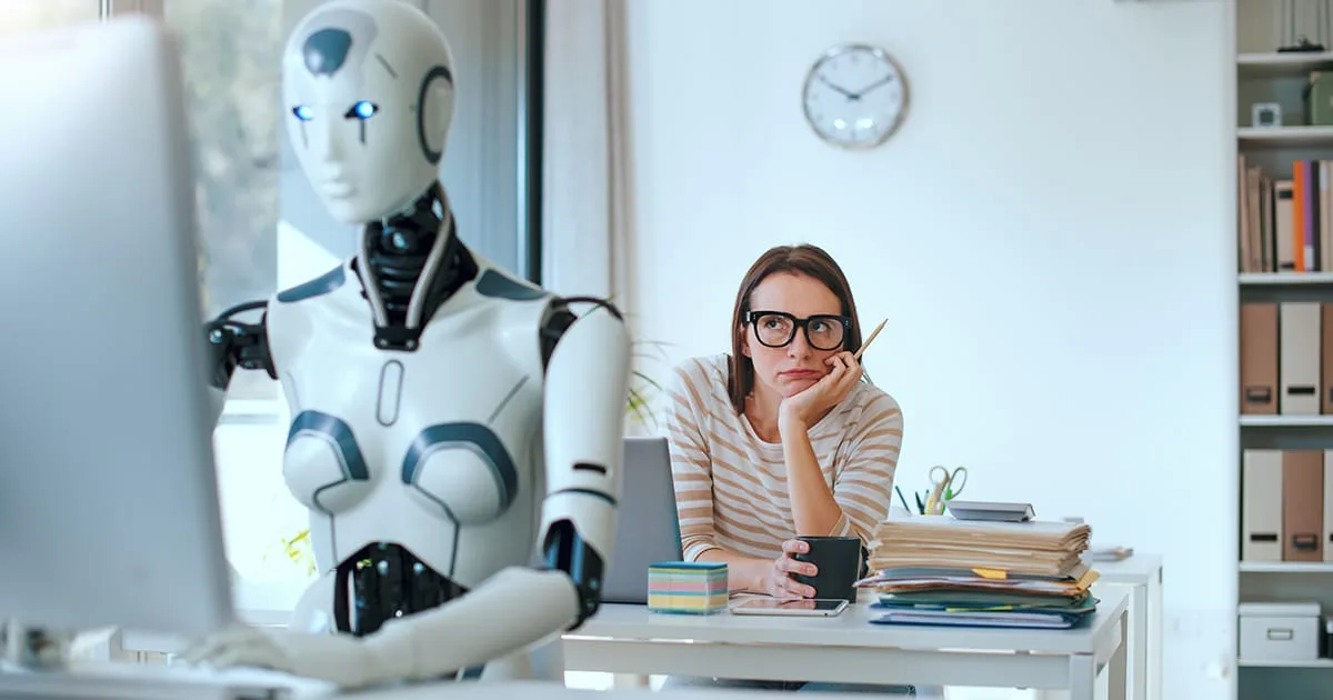 Disappointed stressed woman and AI robot sitting at the office desk and working