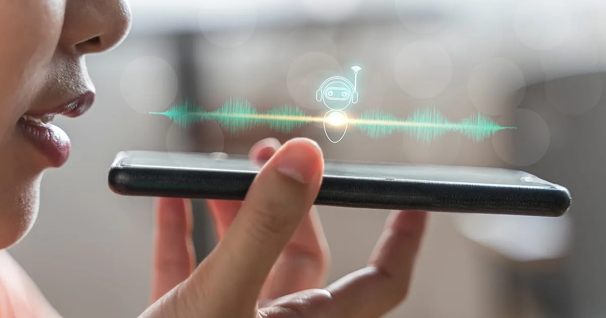 Close up of pretty woman holding in hand smart phone talking with digital assistant