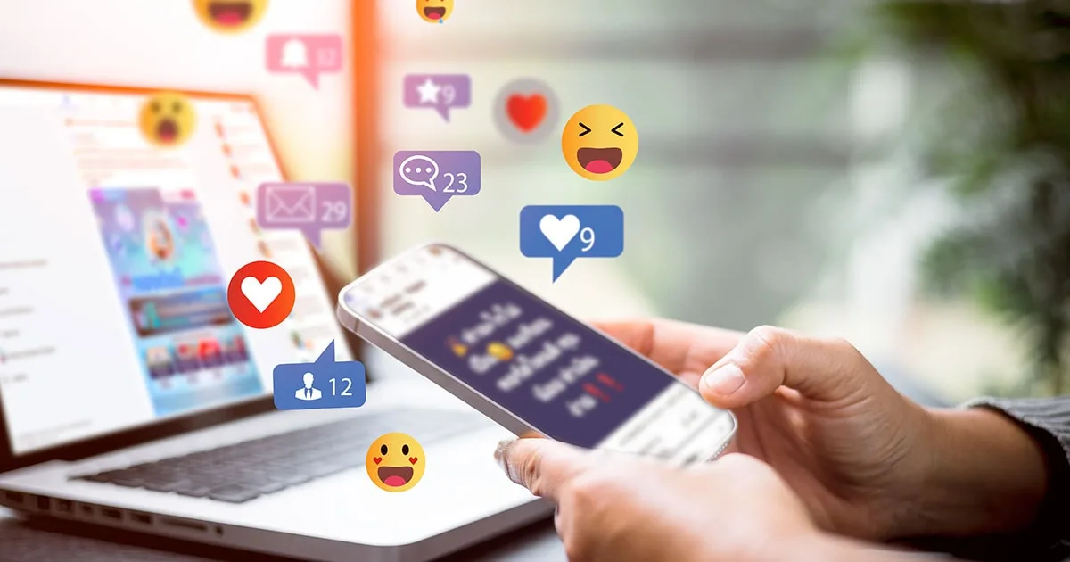 A person using a smartphone with floating social media icons for likes, comments, and notifications.