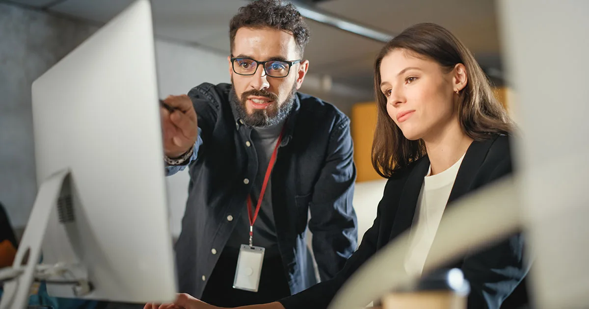 Male and Female collegue discussing AI Ethics and Governance.