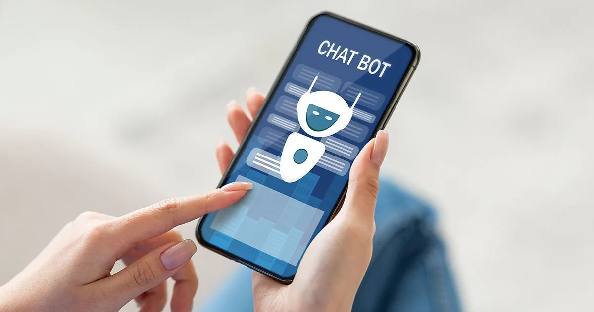 A person using a smartphone with a chatbot interface displayed on the screen, representing AI-powered customer service and automation.